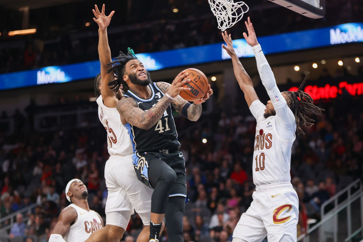Mar 6, 2024; Atlanta, Georgia, USA; Atlanta Hawks forward Saddiq Bey (41) shoots past Cleveland Cavaliers forward Isaac Okoro (35) and guard Darius Garland (10) in the second half at State Farm Arena. Mandatory Credit: Brett Davis-USA TODAY Sports